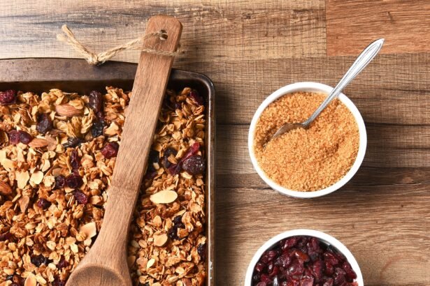 High angle view of fresh homemade granola. Baking sheet filled with the tasty, healthful food with containers of ingredients.